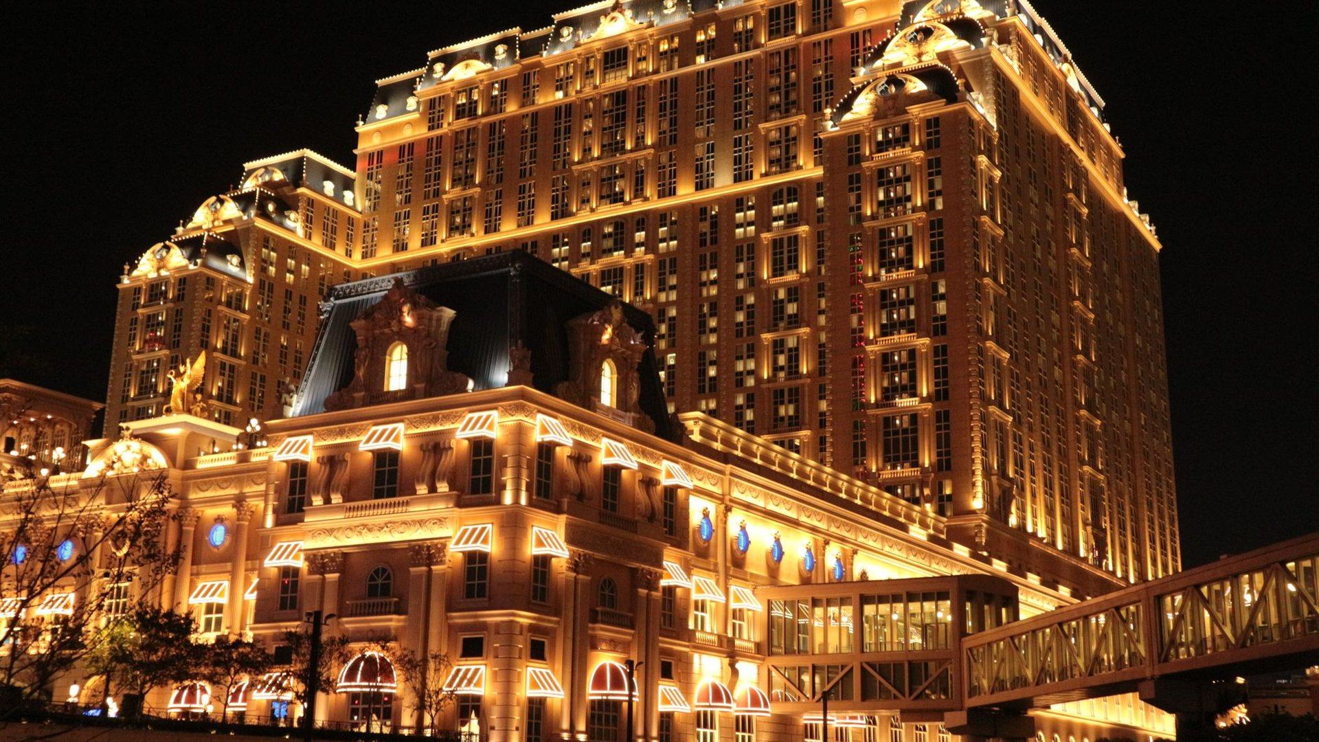 Illuminated casino resort hotel exterior at night